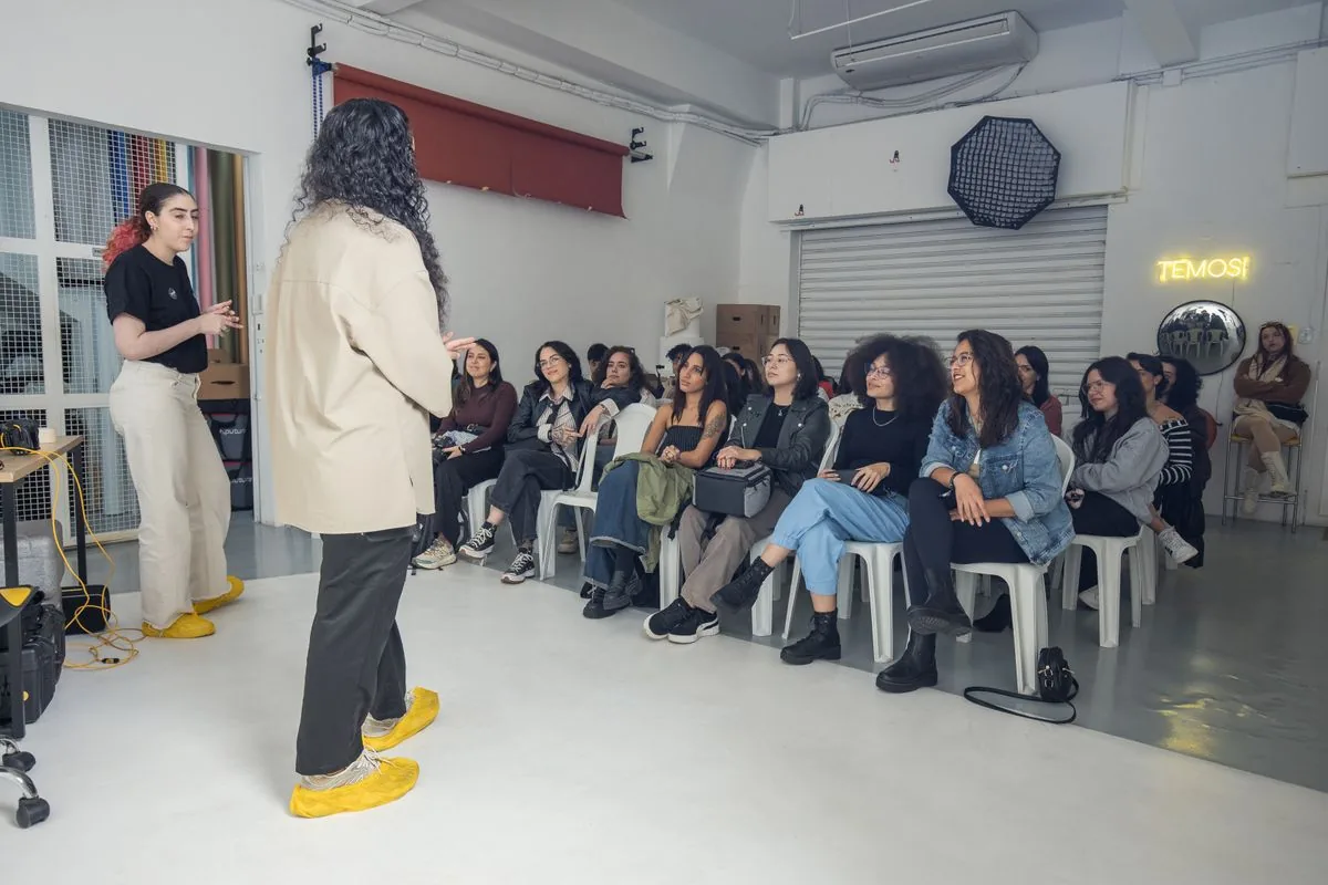 A diverse group of adults listening attentively during a community workshop